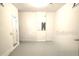 Room featuring light gray walls and painted concrete floor with inset baseboard at 11856 Throttle Pl, Gibsonton, FL 33534