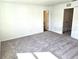 Room with white walls, beige carpeting, white doors and trim, and neutral colors at 11856 Throttle Pl, Gibsonton, FL 33534