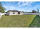 Large backyard showcasing the home's exterior and an expanse of green space at 669 Lakemont Dr, Brandon, FL 33510