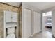 Bathroom including toilet with storage and large closets with bi-fold doors to bedroom at 669 Lakemont Dr, Brandon, FL 33510