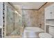 Elegant bathroom features a glass-enclosed shower, soaking tub, and stylish tiling at 669 Lakemont Dr, Brandon, FL 33510