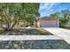 Inviting single-story home featuring a well-maintained lawn and a convenient two-car garage at 669 Lakemont Dr, Brandon, FL 33510