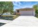 Charming single-story home with a large front yard and two-car garage at 669 Lakemont Dr, Brandon, FL 33510