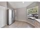Stainless steel refrigerator, a view of a large window and tiled floors at 669 Lakemont Dr, Brandon, FL 33510
