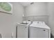 Well-lit laundry room featuring a modern washer and dryer at 669 Lakemont Dr, Brandon, FL 33510