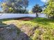 Large backyard featuring a mulched garden area and a new white privacy fence at 4800 86Th N Ave, Pinellas Park, FL 33782