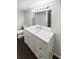 Modern bathroom with white vanity, large mirror, and sleek fixtures at 4800 86Th N Ave, Pinellas Park, FL 33782