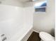 Bright bathroom with tub and window for natural light, accented by modern wood-look flooring at 4800 86Th N Ave, Pinellas Park, FL 33782