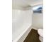 Bright bathroom with tub and window for natural light, accented by modern wood-look flooring at 4800 86Th N Ave, Pinellas Park, FL 33782