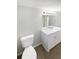 Bright bathroom with white vanity, modern mirror, and fixtures, complemented by wood-look floors at 4800 86Th N Ave, Pinellas Park, FL 33782