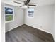 Bright bedroom with wood-look floors and natural light from two windows at 4800 86Th N Ave, Pinellas Park, FL 33782