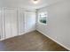 Bedroom with wood-look floors, one window, and closet at 4800 86Th N Ave, Pinellas Park, FL 33782