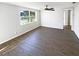 Spacious bedroom with a ceiling fan, large window, and neutral paint colors at 4800 86Th N Ave, Pinellas Park, FL 33782