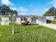 Inviting home exterior featuring a well-manicured lawn, white shutters, and a bright entryway at 4800 86Th N Ave, Pinellas Park, FL 33782