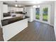 Well-lit kitchen with white cabinetry, stainless steel appliances, and black countertops at 4800 86Th N Ave, Pinellas Park, FL 33782