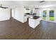 Open floor plan featuring living space and modern kitchen with white cabinets and stainless appliances at 4800 86Th N Ave, Pinellas Park, FL 33782