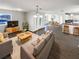 Open-concept living room with hardwood floors and a view into the kitchen and dining area at 4800 86Th N Ave, Pinellas Park, FL 33782
