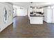 Bright, open-concept living area flowing into the kitchen with modern white cabinets and dark countertops at 4800 86Th N Ave, Pinellas Park, FL 33782