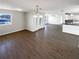 Open-concept living room with hardwood floors and view of front door and kitchen at 4800 86Th N Ave, Pinellas Park, FL 33782