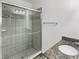 Bathroom features a glass-enclosed shower with tile surround and granite countertop at 5139 Brickwood Rise Dr, Wimauma, FL 33598