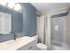 Updated bathroom featuring a modern vanity, brushed metal faucet, and shower with tiled accent wall at 11144 Summer Star Dr, Riverview, FL 33579