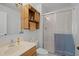 Bathroom with a glass-enclosed shower and a rustic cabinet over the toilet at 11144 Summer Star Dr, Riverview, FL 33579