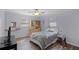Bedroom with neutral walls, a ceiling fan, wood-look floors, and two windows with blinds at 11144 Summer Star Dr, Riverview, FL 33579