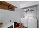 Laundry room featuring a utility sink, shelving, and a washer and dryer at 11144 Summer Star Dr, Riverview, FL 33579