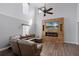 Bright living room featuring a media center with a fireplace and brown wood flooring at 11144 Summer Star Dr, Riverview, FL 33579