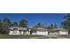 Charming single-story home featuring a well-manicured lawn, inviting entrance, and a spacious two-car garage at 12403 Snowy Egret Ave, Weeki Wachee, FL 34614