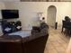 Comfortable living room featuring tile floors, couch, and entertainment center at 12403 Snowy Egret Ave, Weeki Wachee, FL 34614