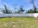 A spacious backyard featuring a well-maintained lawn and a pristine white fence for added privacy at 3527 65Th Avenue E Cir, Sarasota, FL 34243