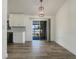 Dining area with wood-look flooring and a view to the screened in patio through sliding glass doors at 3527 65Th Avenue E Cir, Sarasota, FL 34243