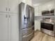 Modern kitchen with stainless steel appliances and white cabinetry, offering a clean and functional cooking space at 3527 65Th Avenue E Cir, Sarasota, FL 34243