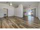 Open-concept living room with wood-look flooring, white walls, and sliding glass doors leading to the outdoors at 3527 65Th Avenue E Cir, Sarasota, FL 34243