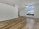 Open floor plan living area featuring hardwood flooring and plenty of natural light at 3527 65Th Avenue E Cir, Sarasota, FL 34243