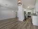 A spacious open-concept living area with a modern kitchen, stainless appliances, and wood-look flooring at 3527 65Th Avenue E Cir, Sarasota, FL 34243