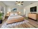 Spacious main bedroom with stylish decor, a ceiling fan, and a walk-in closet at 3527 65Th Avenue E Cir, Sarasota, FL 34243