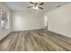 Bright main bedroom showcasing wood flooring, a ceiling fan and a modern neutral color palette at 3527 65Th Avenue E Cir, Sarasota, FL 34243