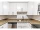 Close-up of a kitchen with granite countertops, white cabinets, and stainless steel sink at 545 Frandor Pl, Apollo Beach, FL 33572