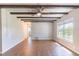 Bright and airy living room features wood floors, rustic beamed ceilings, and natural light at 545 Frandor Pl, Apollo Beach, FL 33572