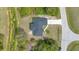 Overhead view of home and lot showing roof, driveway, and surrounding trees at 8896 Wawana Rd, North Port, FL 34287