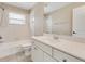 Bathroom with white vanity, sink, toilet, shower, and tub at 8896 Wawana Rd, North Port, FL 34287