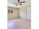 Bedroom with tile floors, ceiling fan, and a view from the window at 8896 Wawana Rd, North Port, FL 34287