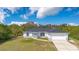 Charming single-story home with a well-manicured lawn and attached two-car garage at 8896 Wawana Rd, North Port, FL 34287