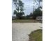 Spacious backyard with lush greenery, mature trees, and a small storage shed at 15168 Chamberlain Blvd, Port Charlotte, FL 33953