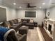 Cozy living room featuring a large sectional, fireplace, and neutral color palette at 15168 Chamberlain Blvd, Port Charlotte, FL 33953