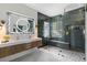 Bathroom featuring modern double sink vanity, a lighted mirror, and a glass enclosed shower at 19104 Redbay Way, Tampa, FL 33647