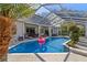 Clean, screened-in pool with an outdoor lounging area at 19104 Redbay Way, Tampa, FL 33647