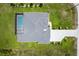 Aerial view showcases a well-maintained home with a screened-in pool, complemented by lush green landscaping at 291 Rotonda S Blvd, Rotonda West, FL 33947